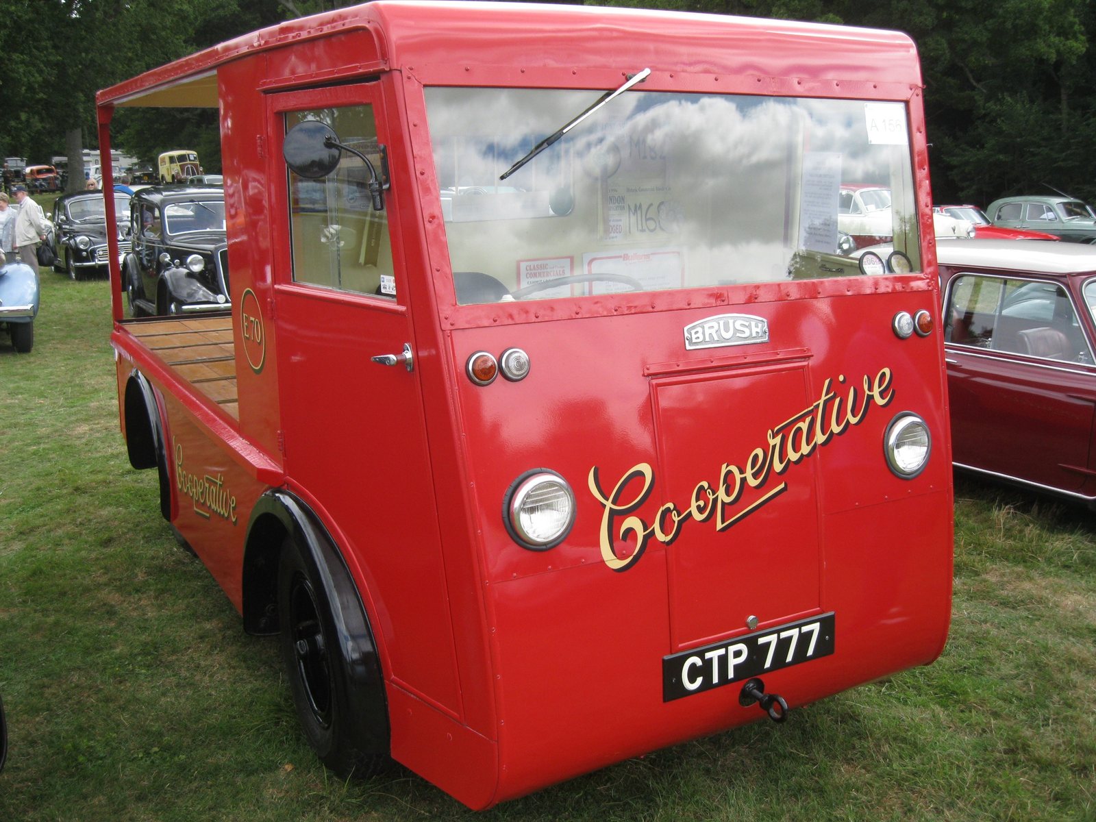 A restored red 1946 Brush Co-operative electric milk float